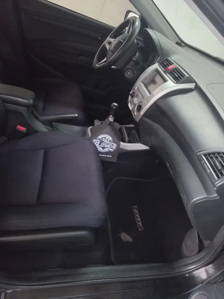 Interior de carro higienizado: bancos, console e tapetes limpos.